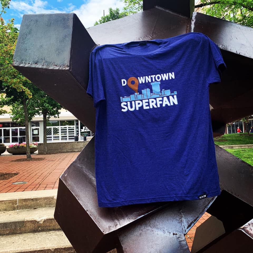 A blue Downtown Superfan T-shirt hangs on the Tumbler in Park Central Square